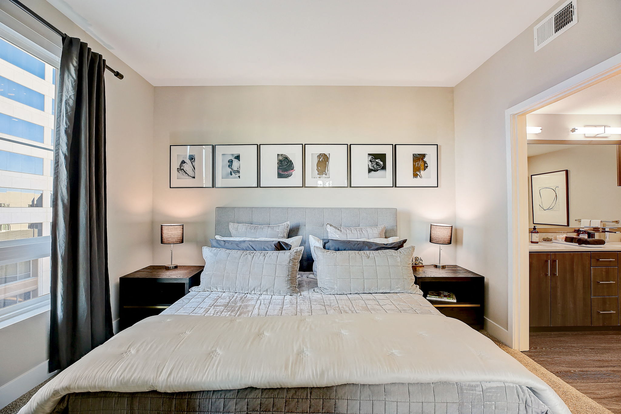 Bedroom with bed and framed pictures at Eleven 10 in Orange, CA,Bedroom with bed and framed pictures at Eleven 10 in Orange, CA